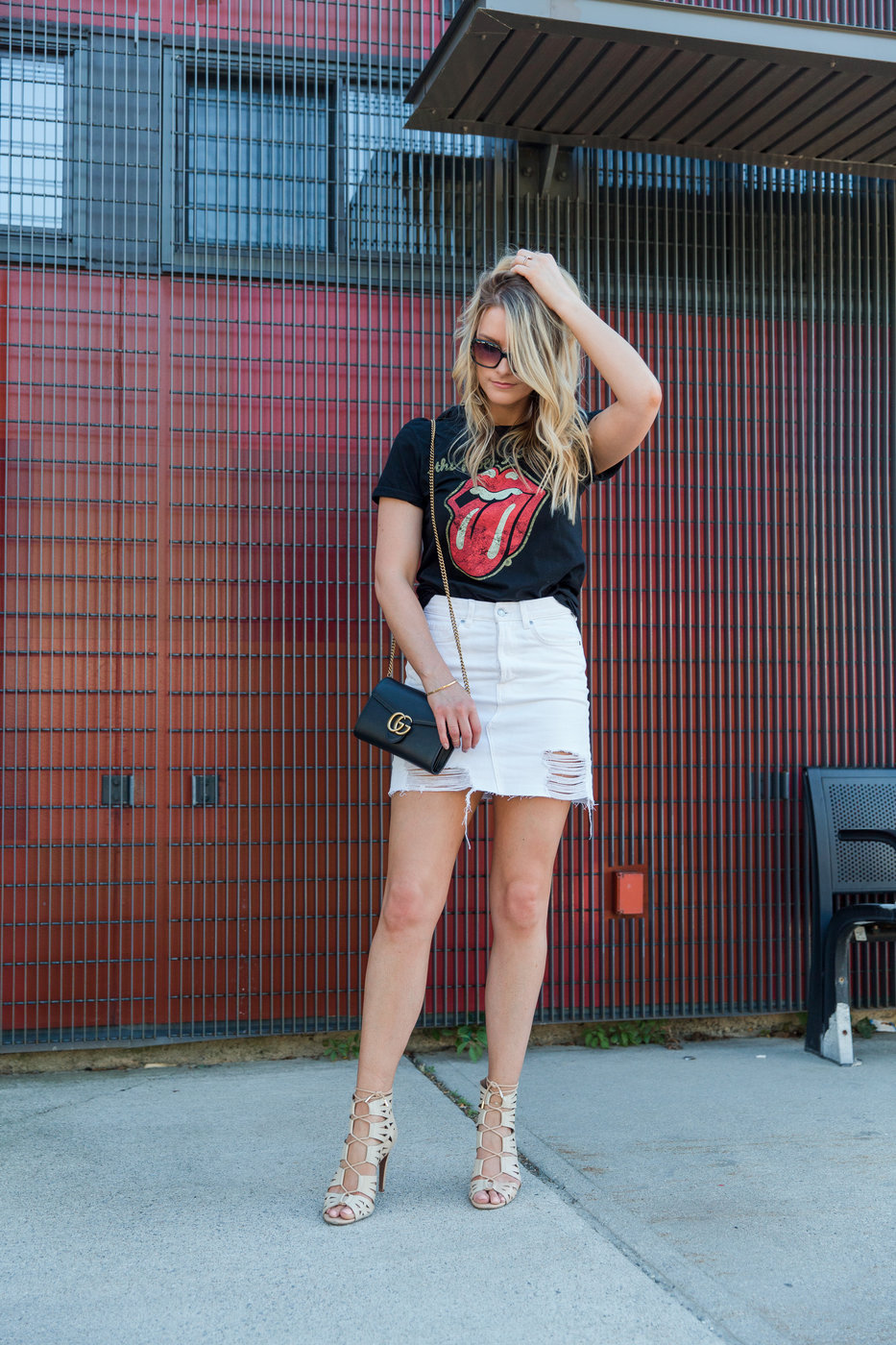 1 person, girl wearing Rolling Stones t-shirt and white denim skirt with Gucci bag