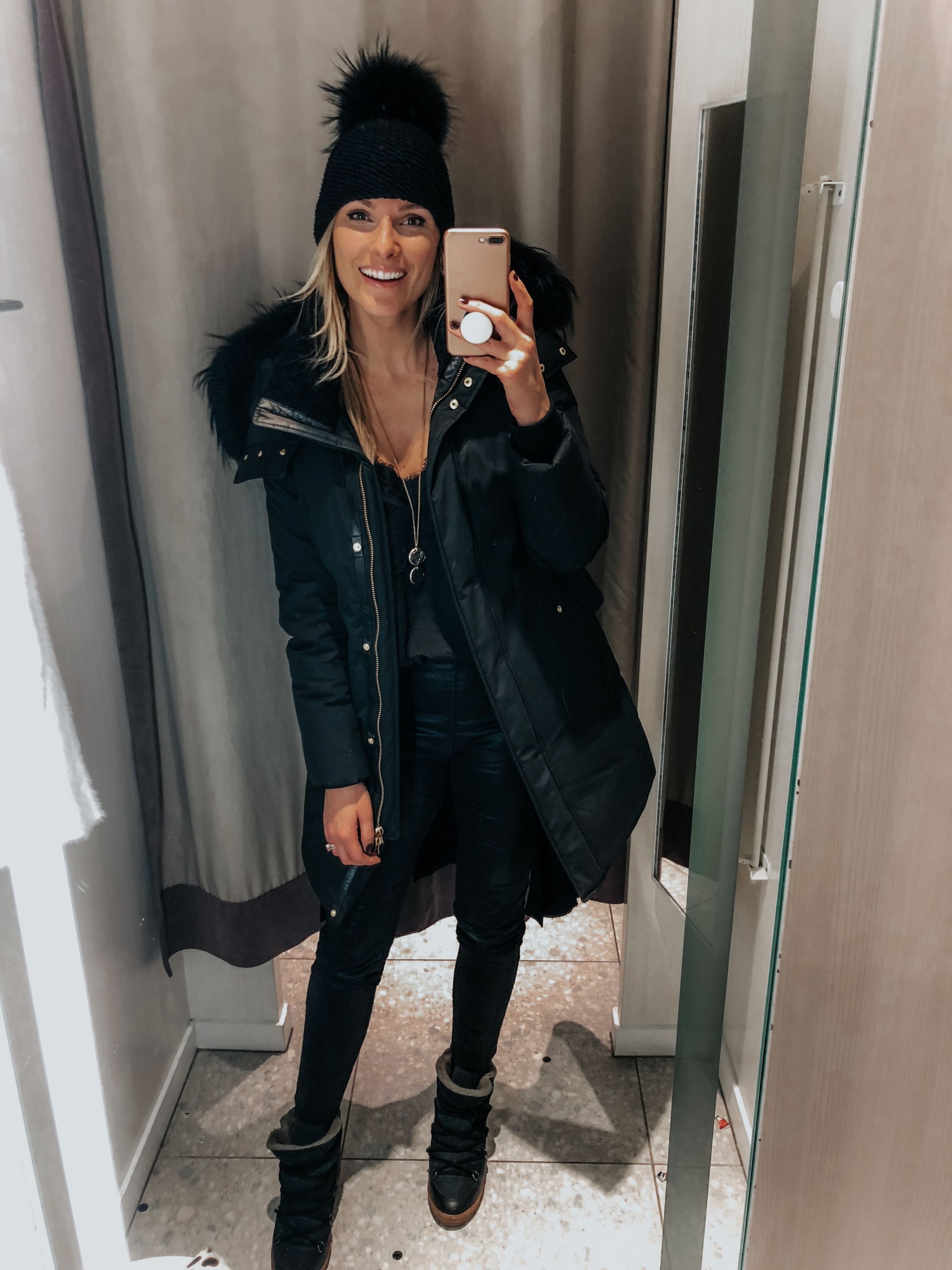 girl in fitting room, selfie, girl wearing winter jacket and hat