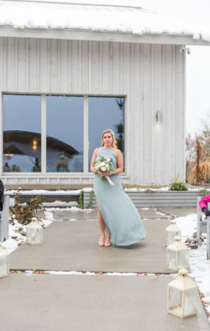 bridesmaid coming down the aisle in show me your mumu dress heather style at le belvedere