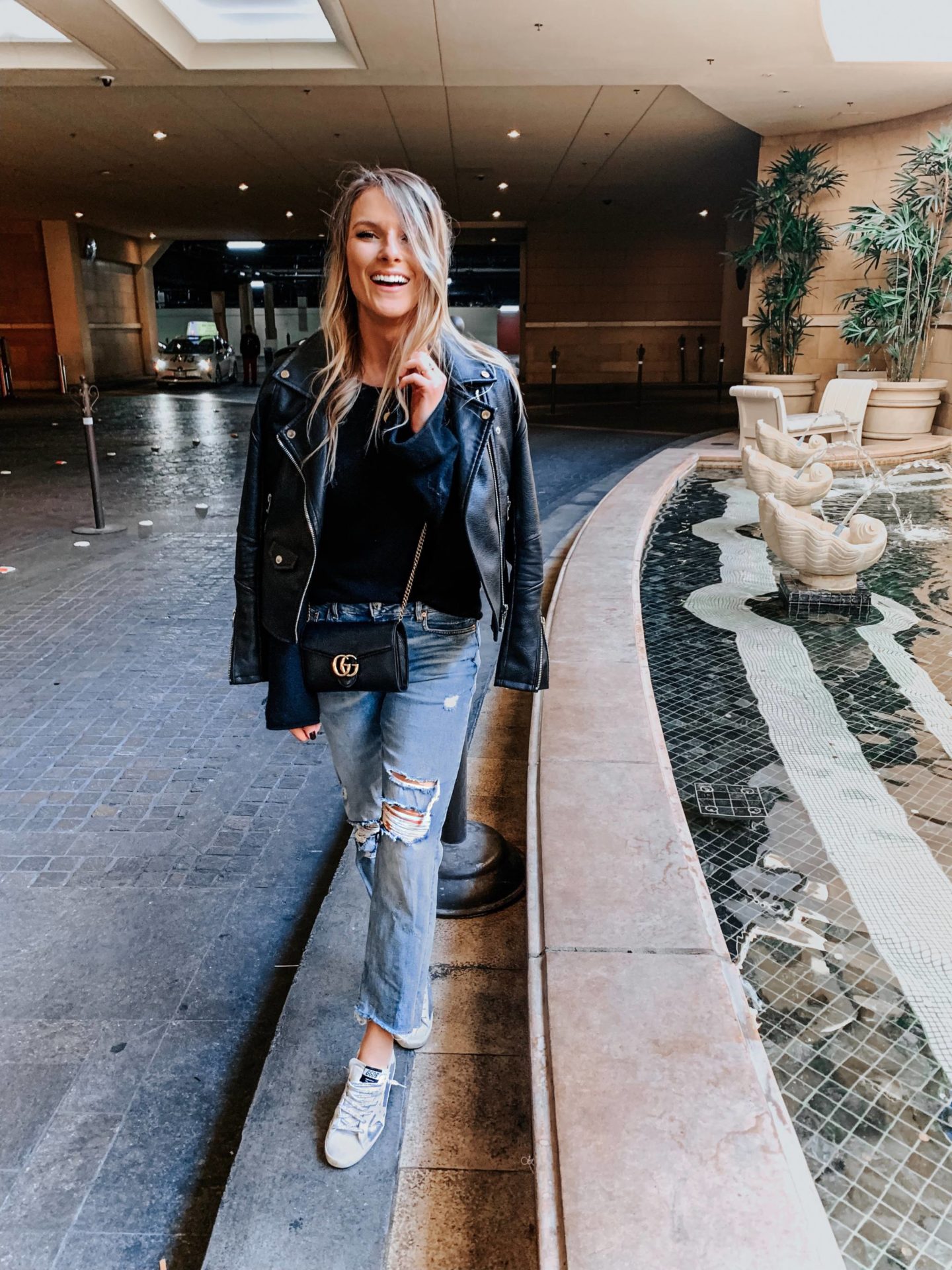 blonde girl wearing distressed denim and golden goose shoes in las vegas