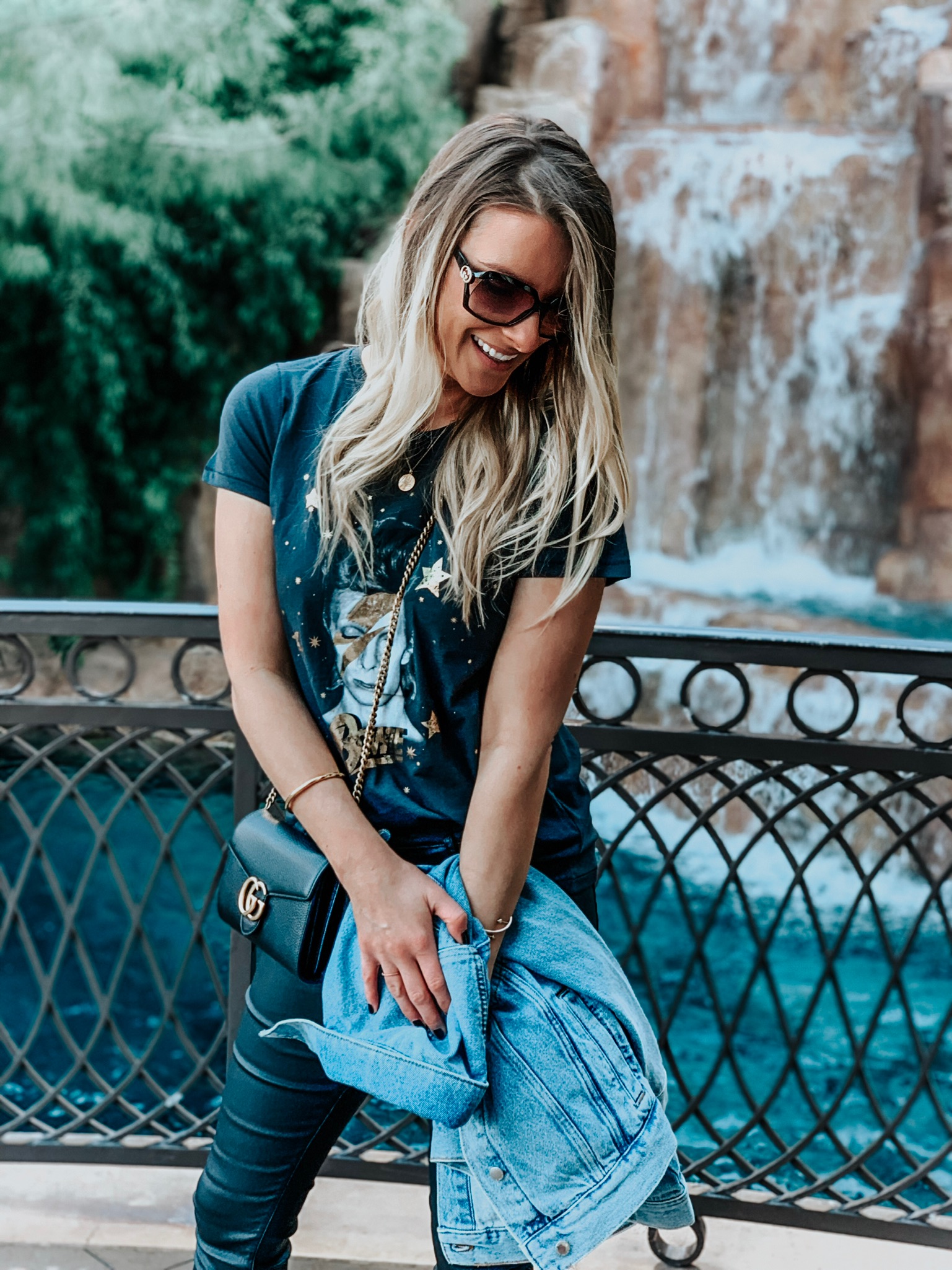 girl laughing and wearing a David bowie tee