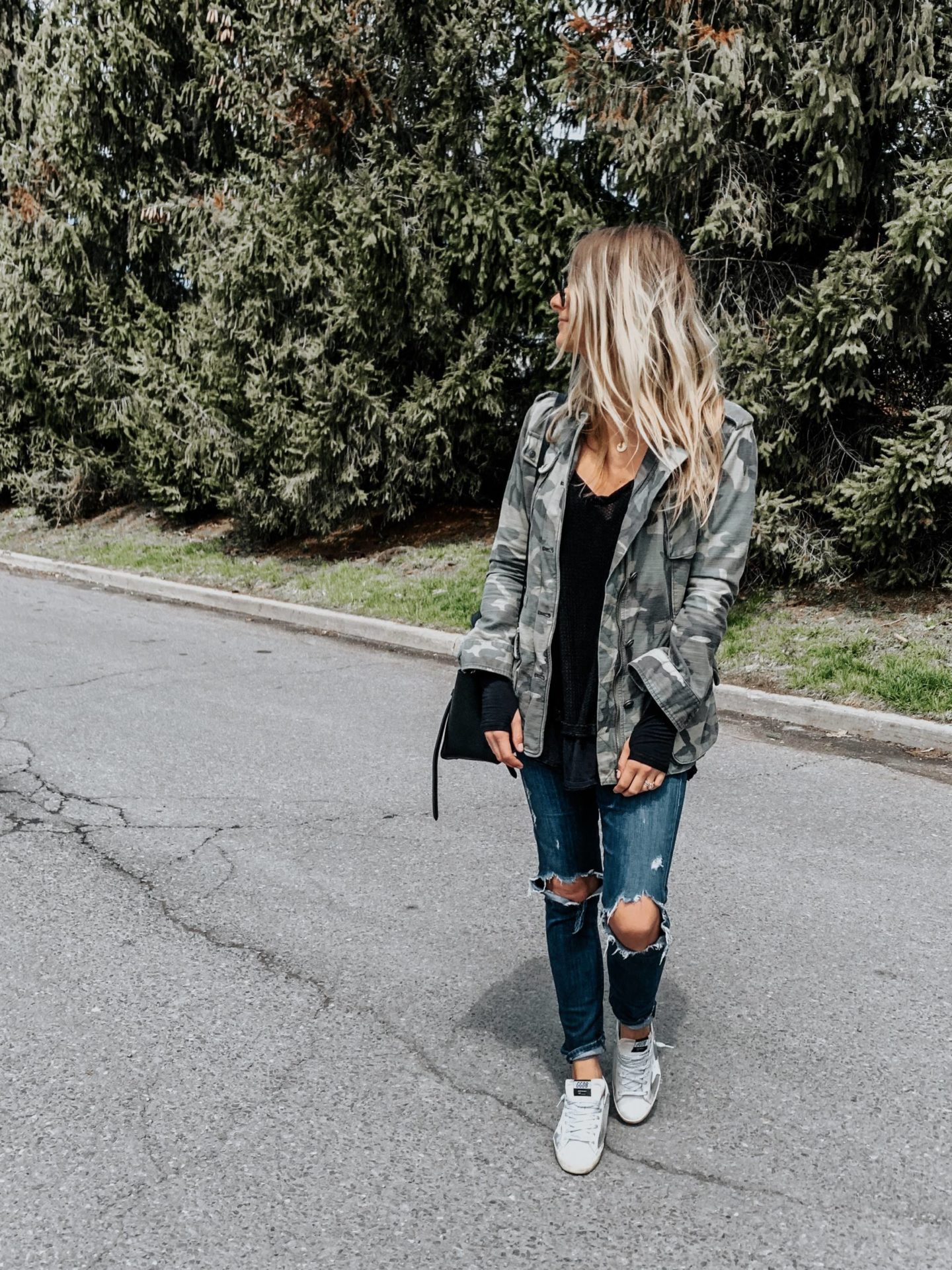 blonde girl wearing camo jacket and sneakers, casual outfit