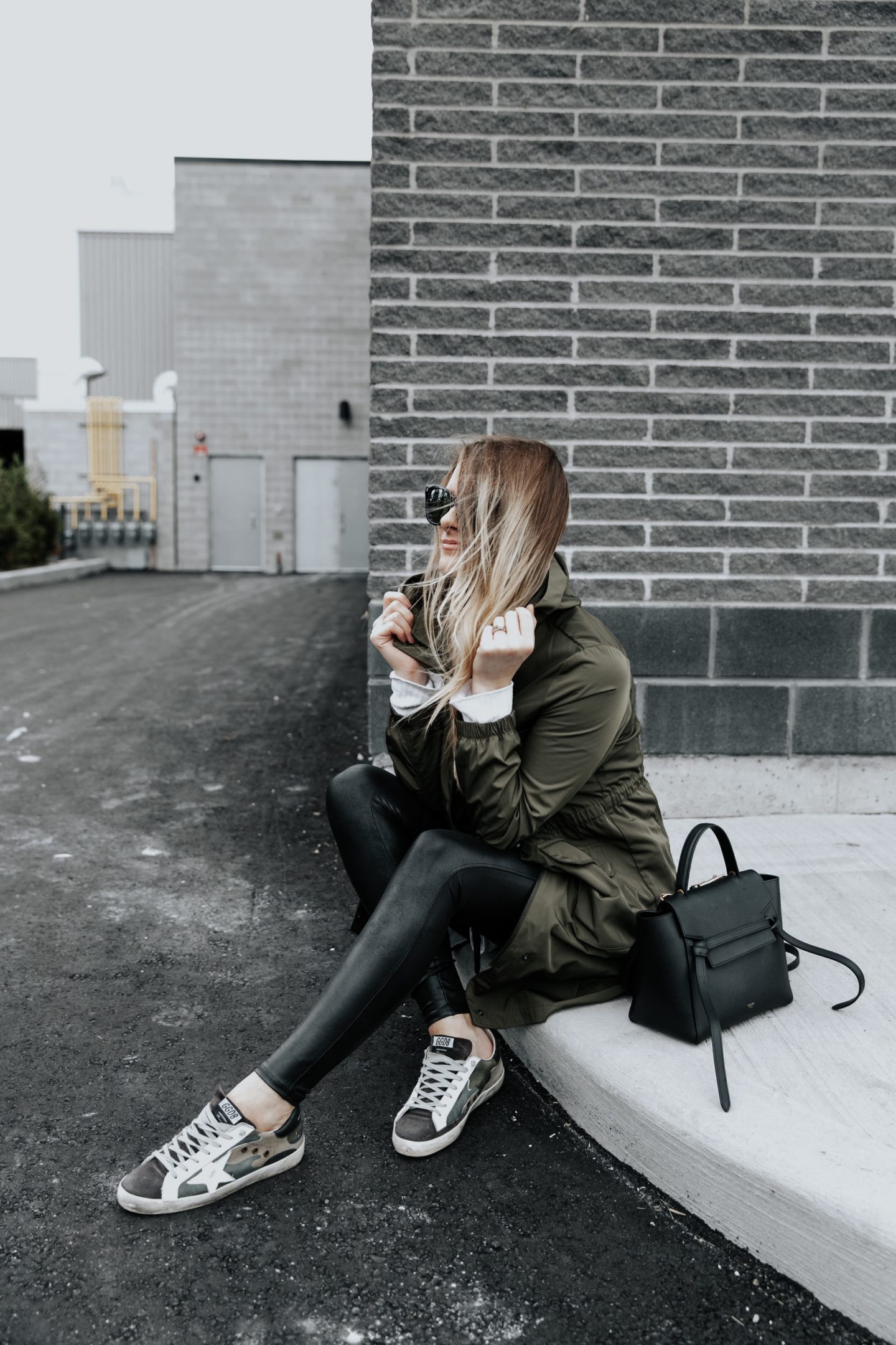 girl sitting wearing cute fall outfit and Celine belt bag